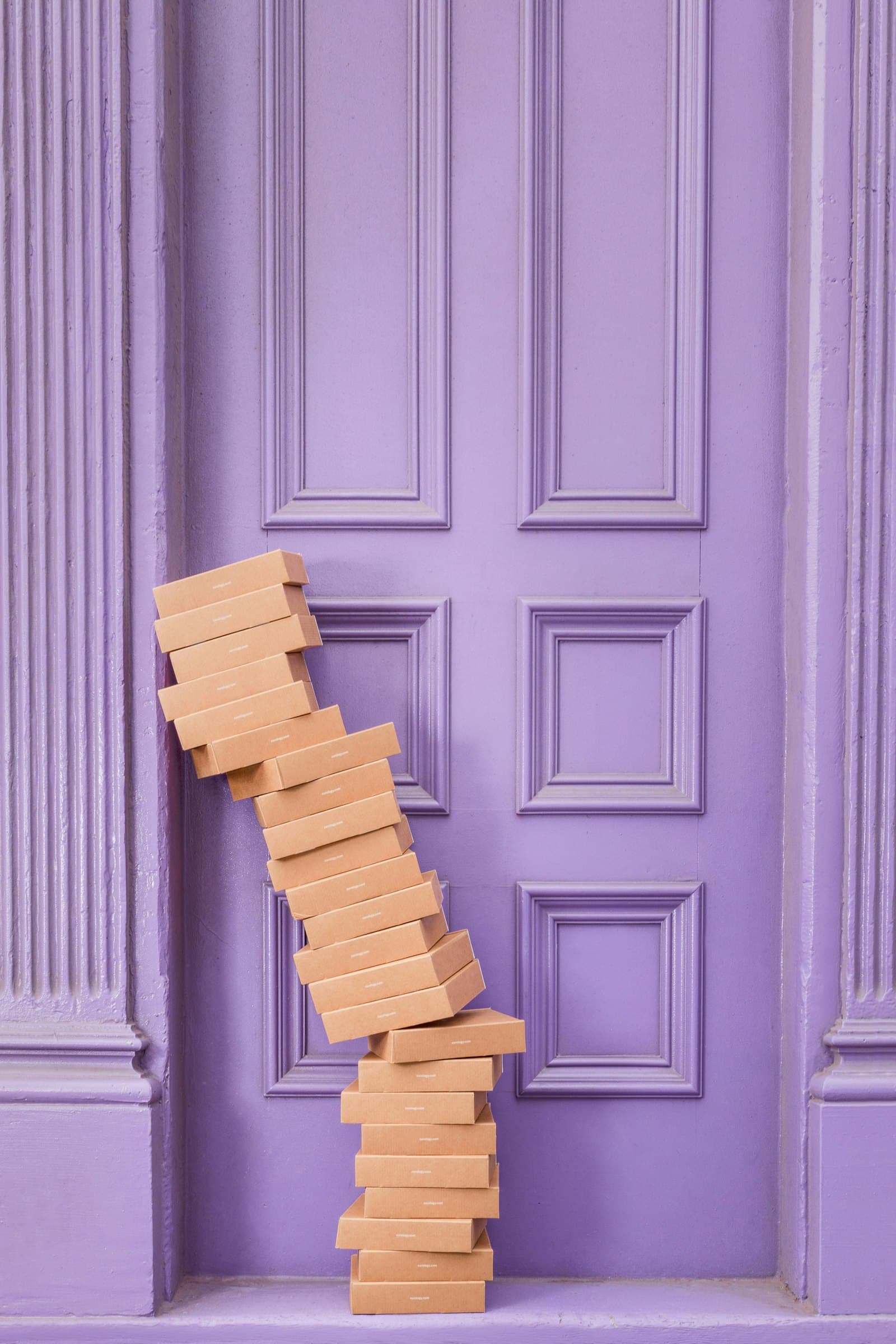 Stacked wooden blocks leaning against lavender paneled doors